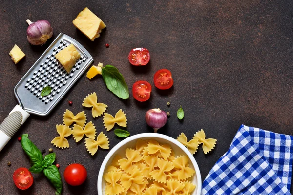 Food frame. Ingredients for pasta - cherry tomatoes, garlic, basil, Parmesan, top view.