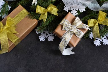 Mutlu yeni yıl ve mutlu Noeller. Noel hediyeler köknar siyah bir arka plan ile besleme hazneleri.