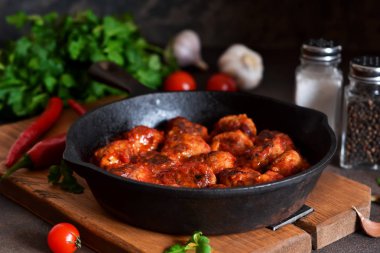 Mutfak masasının üzerinde tatlı ve ekşi domates soslu köfte. 