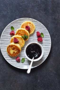 Kahvaltı zamanı. Kahvaltı için ahududu sosu ile peynir kekler 