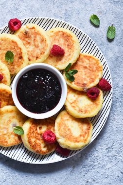 Kahvaltı zamanı. Kahvaltı için ahududu sosu ile peynir kekler 