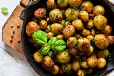 Kızarmış, tavada fesleğenli genç patatesler. Yukarıdan görüntüle.