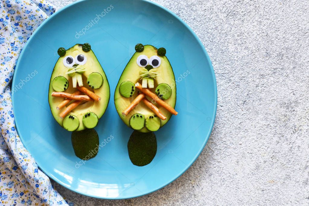 Lunch for the child. Funny beavers from avocado in a plate