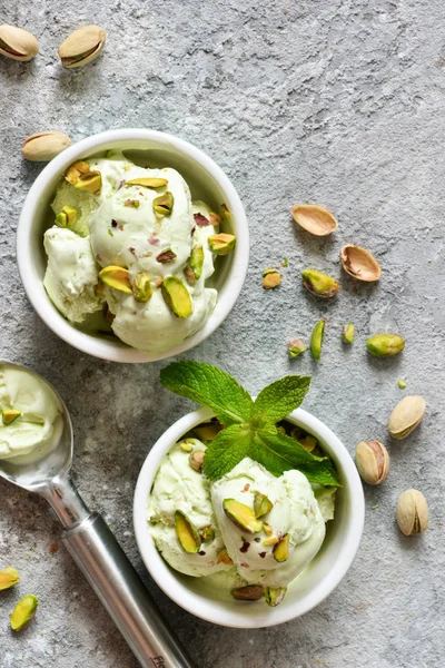 Pistachio ice cream with mint on a stone background. — Stock Photo, Image
