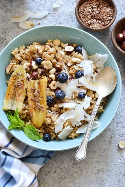 Oatmeal with caramel, banana, blueberries and coconut chips