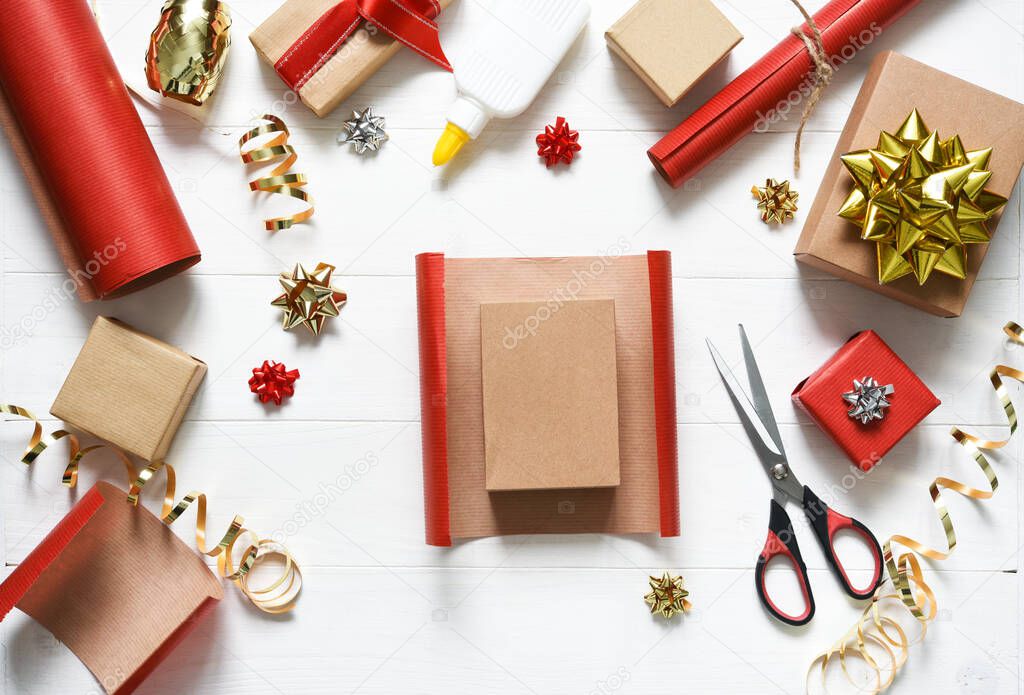 Gift wrapping accessories. Beautiful ribbons and boxes with gifts on a white wooden background.