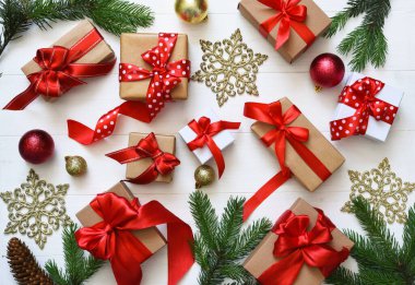 Beyaz arka planda güzel bir noel kompozisyonu. Kırmızı kurdeleli birçok farklı hediye kutusu..