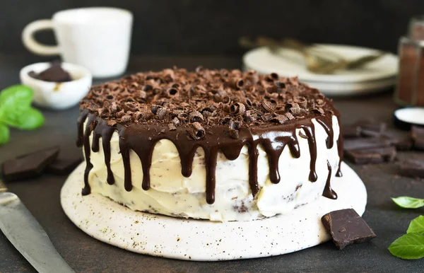 Chocolate truffle cake with cream cheese on a dark background.
