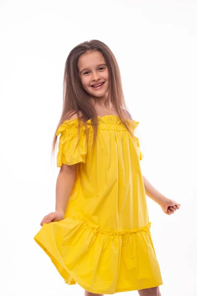 Estúdio tiro de uma menina sorridente vestindo sundress amarelo em — Fotografia de Stock