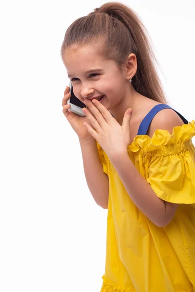 Studio shot of a little smiling girl wearing  yellow sundress an — Stock Photo, Image