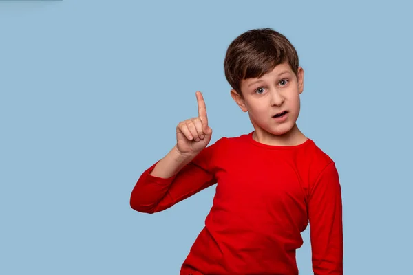 Studio shot of a boy proving something by raising his index fing — Stock Photo, Image