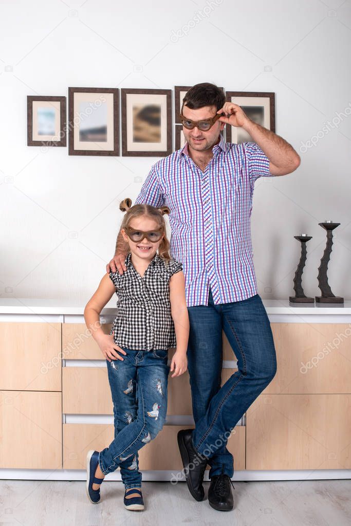 Studio shot of a daughter and dad standing  in the room in ident