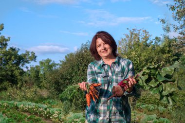 Havuç ve l bir ürün ile gülümseyen yaşlı bir kadının Portresi
