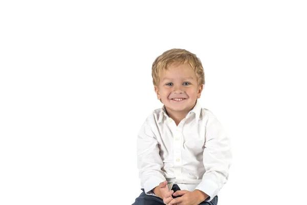 Half length portrait of a little smiling boy  siting against whi — Stock Photo, Image