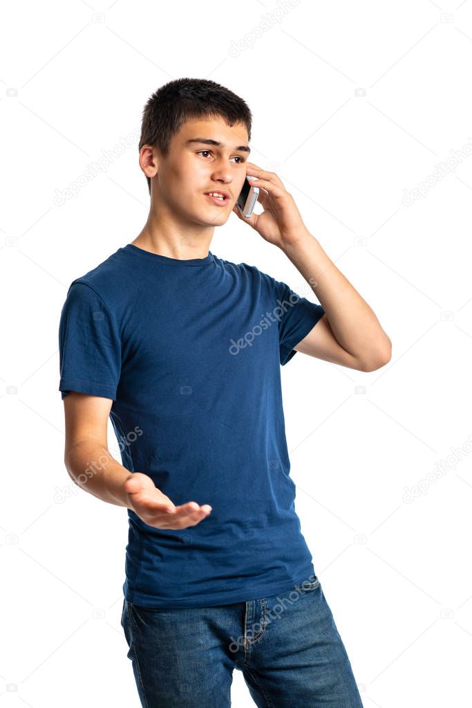 Young boy teenager  emotionally speaks on the phone with a hand 