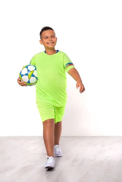 Studio portrait of a positive smiling mixed race boy in green fo — Stock Photo, Image
