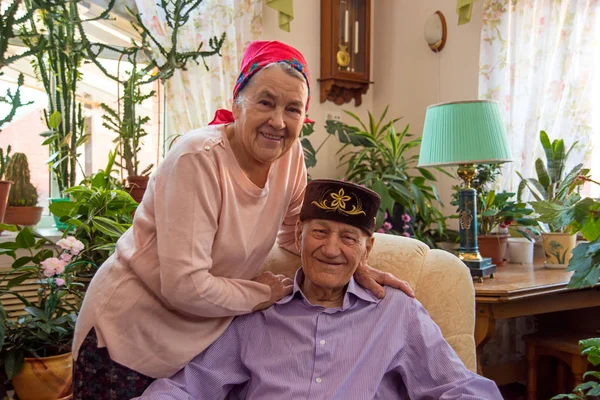 Shot of a senior couple using a laptop together at home. Shot of a happy elderly couple using a laptop while relaxing at a table together at home. Shot of a happy elderly couple using laptop while sitting together at a table at home