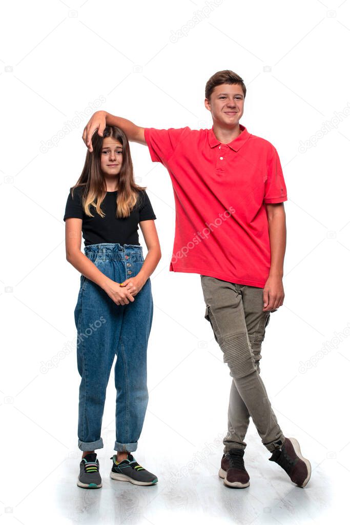 Shot of funny teenagers, boy and girl, sorting things out in a joking manner