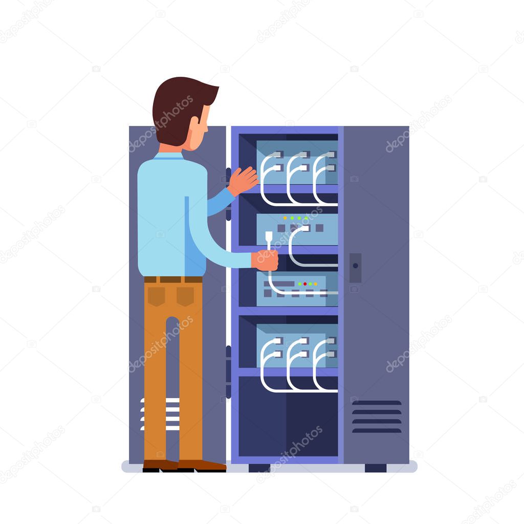 Sysadmin man working with server rack switchboard
