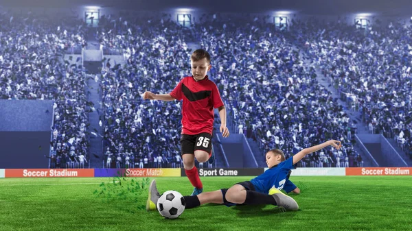 2 children football players in scrimmage for the ball on a stadium — Stock Photo, Image