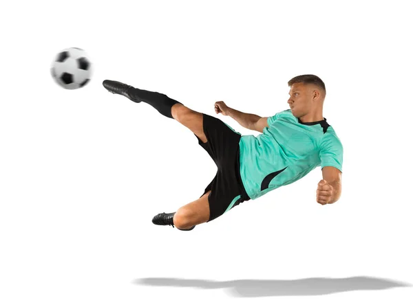 Jogador de futebol chutando a bola no ar isolado em branco — Fotografia de Stock