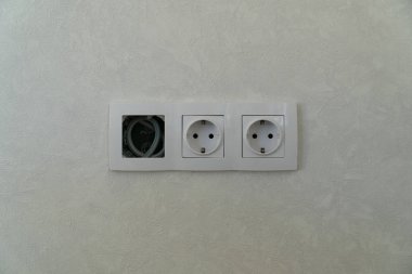Two Power and free sockets with frame on white wall as a background