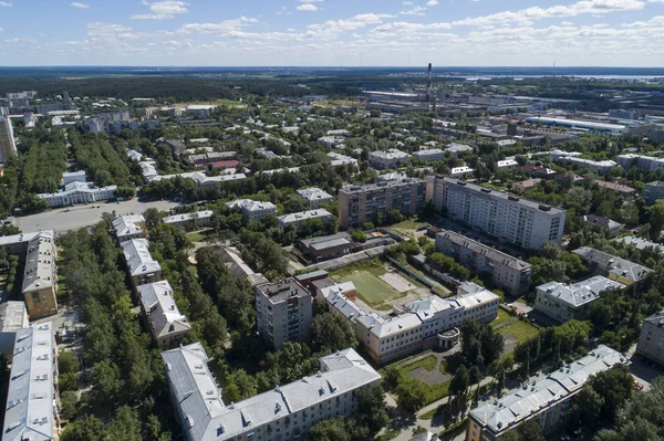 Top down aerial drone image of a Ekaterinburg city in the midst of summer, backyard turf grass and trees lush green. — Stock Photo, Image