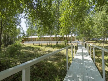 white small bridge to marquee tent, glade, summer, sunny