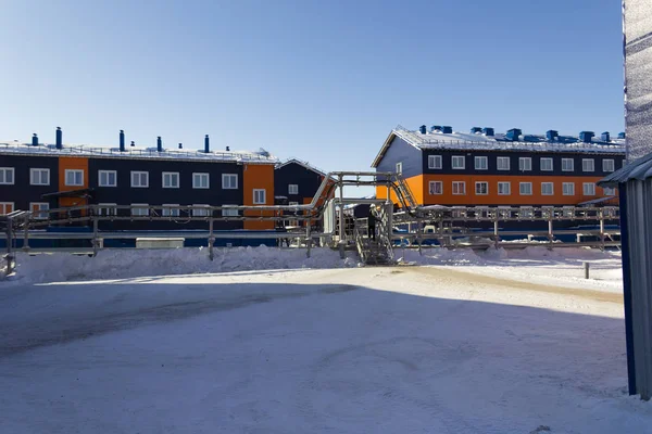 Hostel building. Sandwich panels painted in blue and orange. Port Sabetta, Yamal, Russia