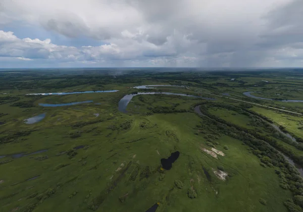 River and lakes near the Irbit city . Russia. Aerial. Summer, cloudy.  A lots of trees and grass