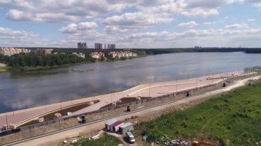 Nehir kıyısındaki setin havadan fener, bank ve stadyumlu manzarası. Karşı kıyıda, modern çok katlı evler. Güneşli bir yaz günü. Rusya, Ekaterinburg