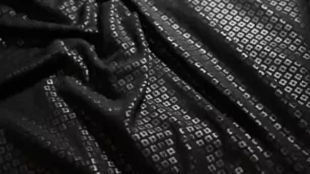 Black sequins texture sliding along table — Stock Video