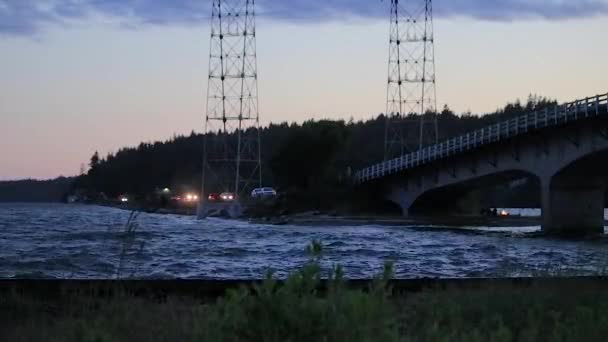 Éclaboussant l'océan sous le pont en soirée — Video