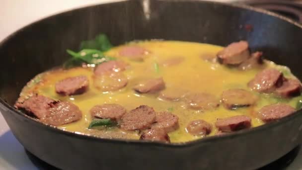 Spicing eggy sausage and greens — Stock Video