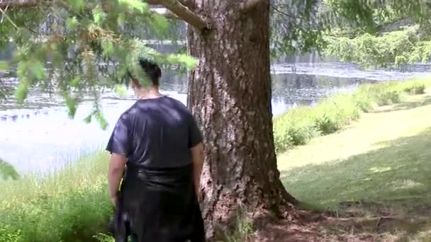 Jeune homme assis sous l'arbre — Video