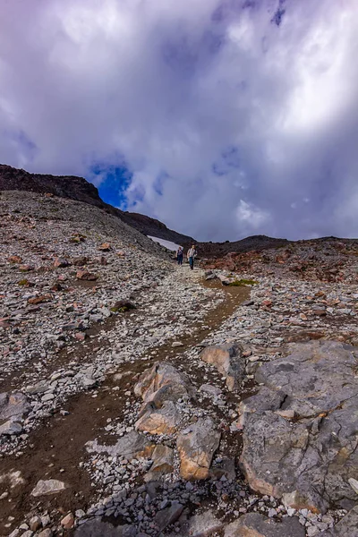 Red gravel mountain top under blue sky with white clouds — Stock Photo, Image