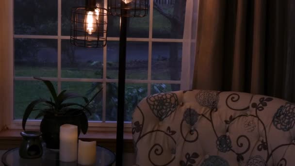 Dim interior light looking out at evening snow — Stock Video