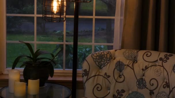 Slow snowfall outside window with lights and candles — Stock Video