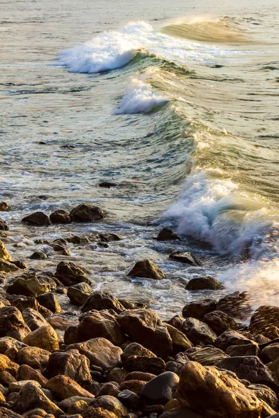 Golven breken met schuim, op rotsachtige kustlijn — Stockfoto