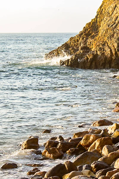 ocean wave meeting cliff edge along rocky shoreline