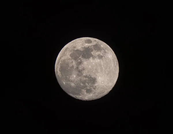 Zoomed into the almost full moon in a night sky — Stock Photo, Image