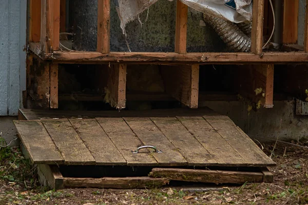 Old wooden hatch to crawlspace damaged — Stock Photo, Image