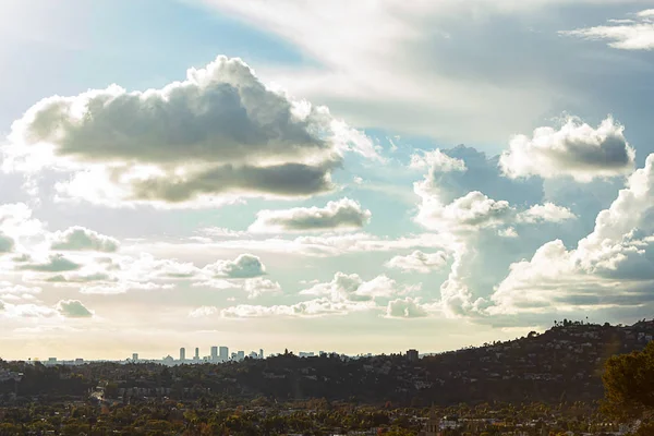 Panaramic view of city businesses and homes with hillside homes and downtown LA towers in the distance — стоковое фото