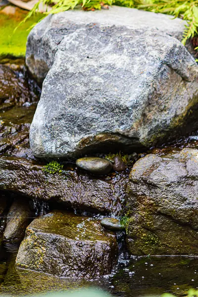 Γρανίτη βράχια με νερό που ρέει κάτω από το βράχο πρόσωπο σε μικρή πισίνα — Φωτογραφία Αρχείου