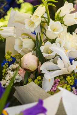 taze parlak ve renkli çiçek buketleri yerel bir çiftçi pazarında beyaz kağıt ile sarılmış