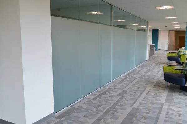 clean white office hallway with industrial doors and windows on the walls