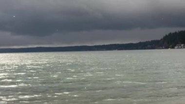 Küçük dalgalar bulutlu bir günde kayalık bir sahilde dalgalanır.