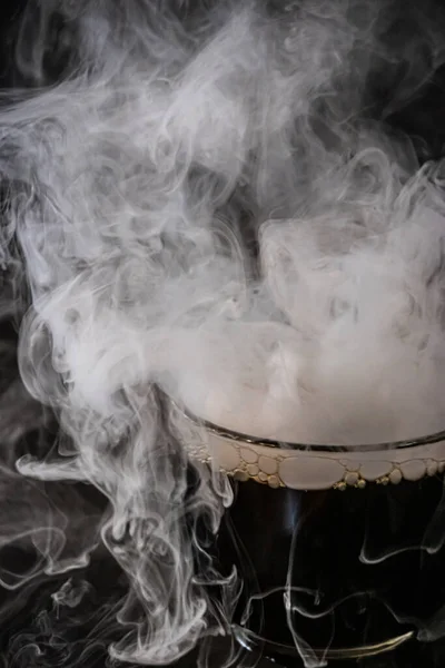 various glasses and dishes with water and dry ice