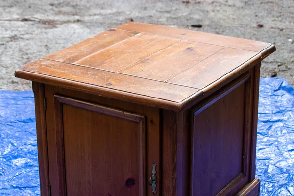 old antique table set out on a blue tarp