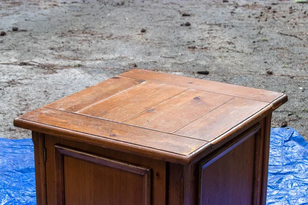 old antique table set out on a blue tarp